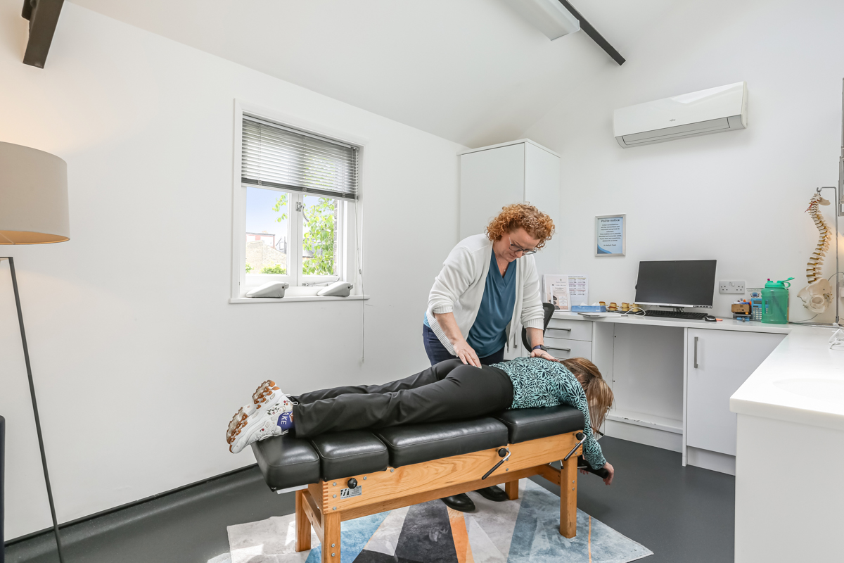 Kelly treating a patient with back pain at Kingston Chiropractic & Wellness Centre
