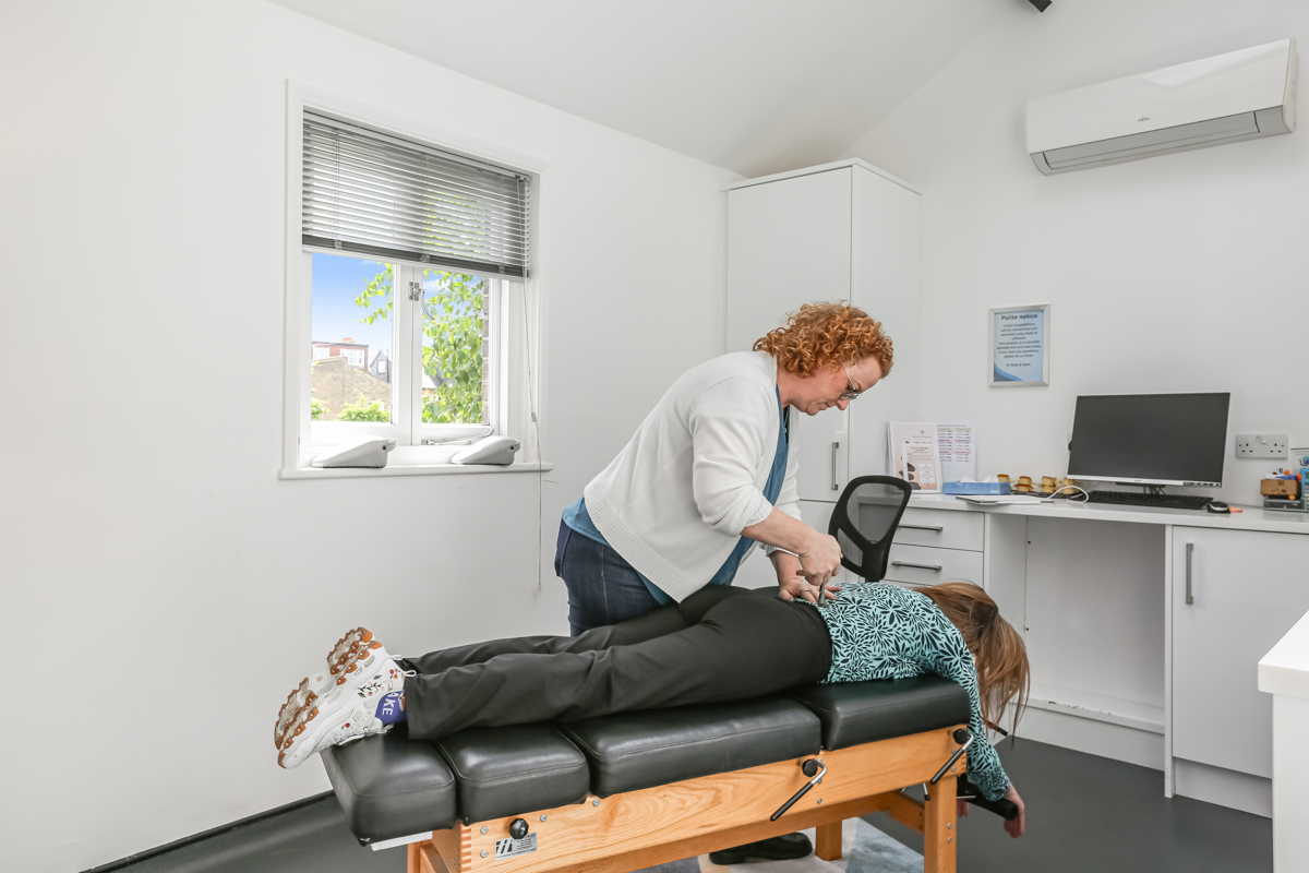 Kelly performing a spinal adjustment at Kingston Chiropractic